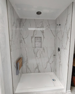 Walk-in shower with marble tile